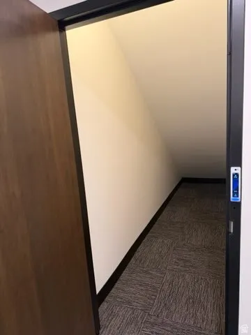 Hall with elevator and dark carpet