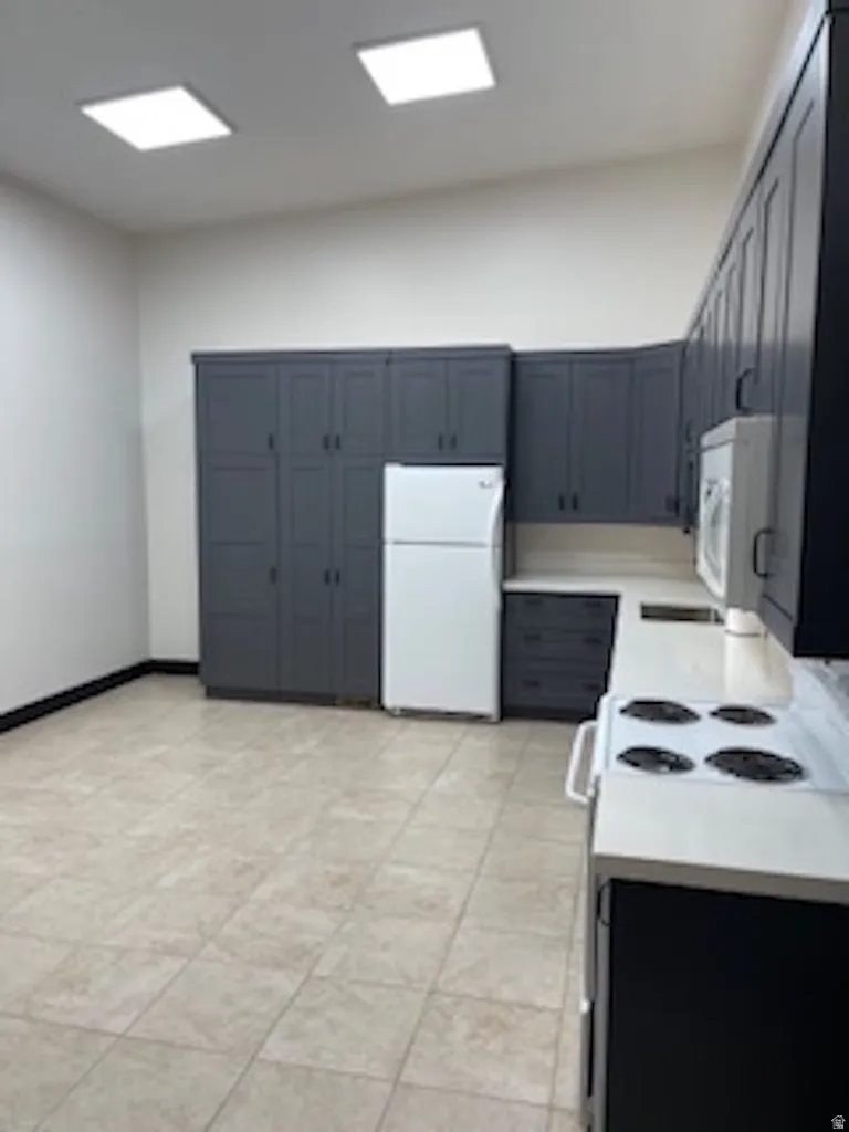 Kitchen with white appliances and light countertops