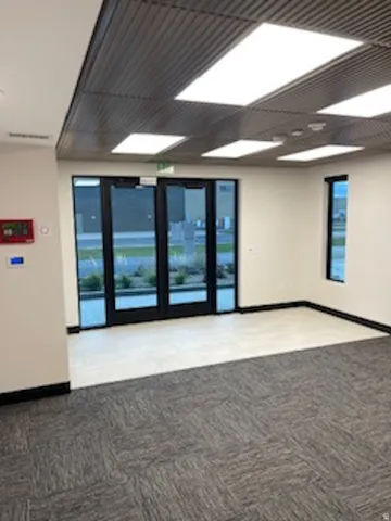 Unfurnished room with baseboards and light carpet