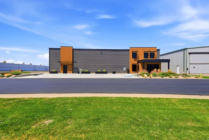 Building exterior featuring a grey metal facade with wood-finish paneling accents