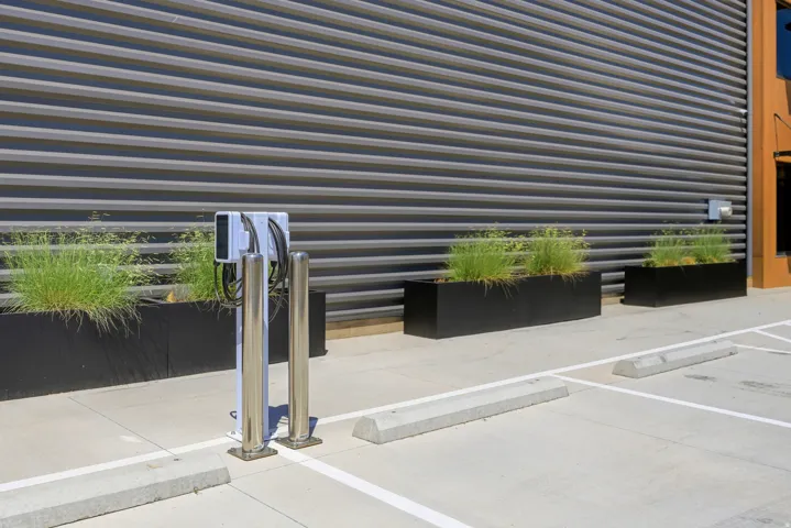 Dedicated EV charging station with dual ports, positioned on concrete paving