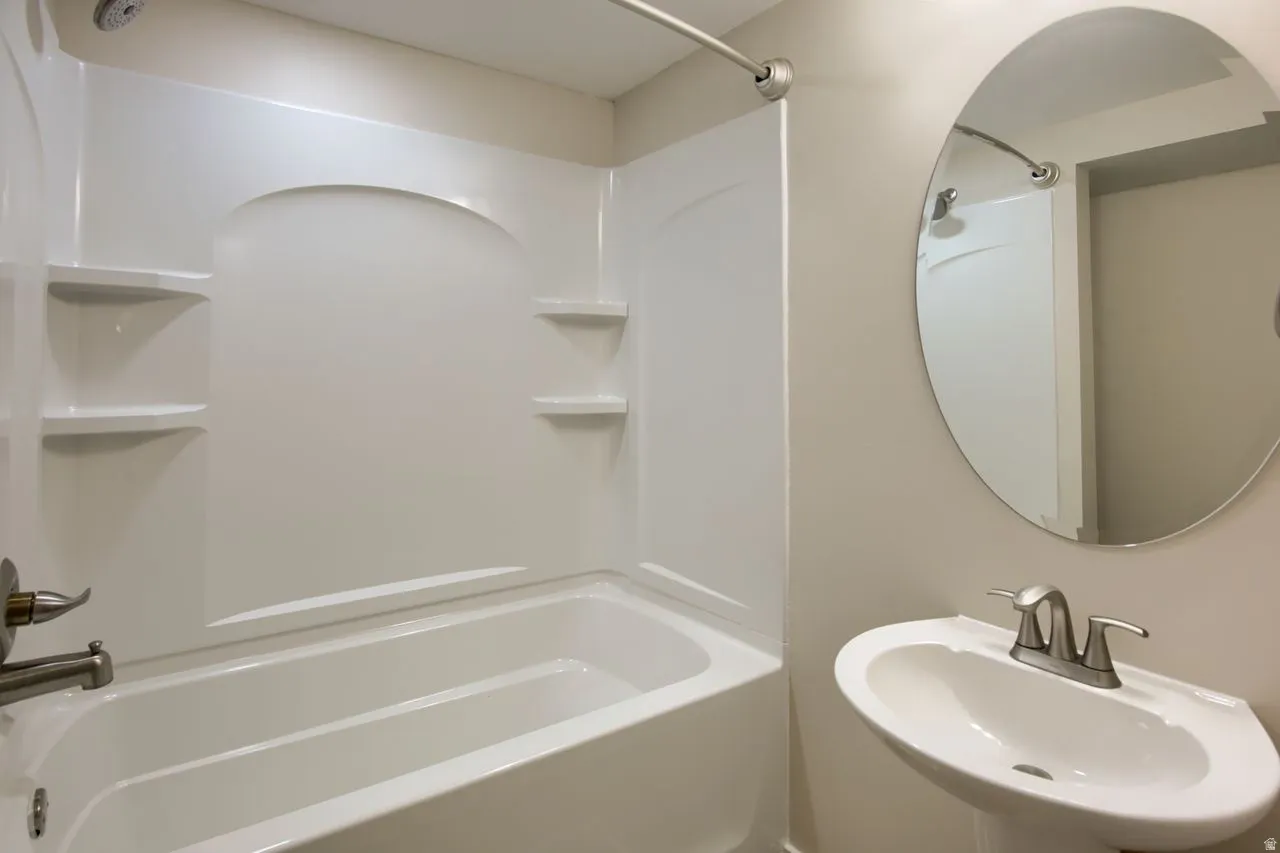 Bathroom with shower / tub combination and a sink