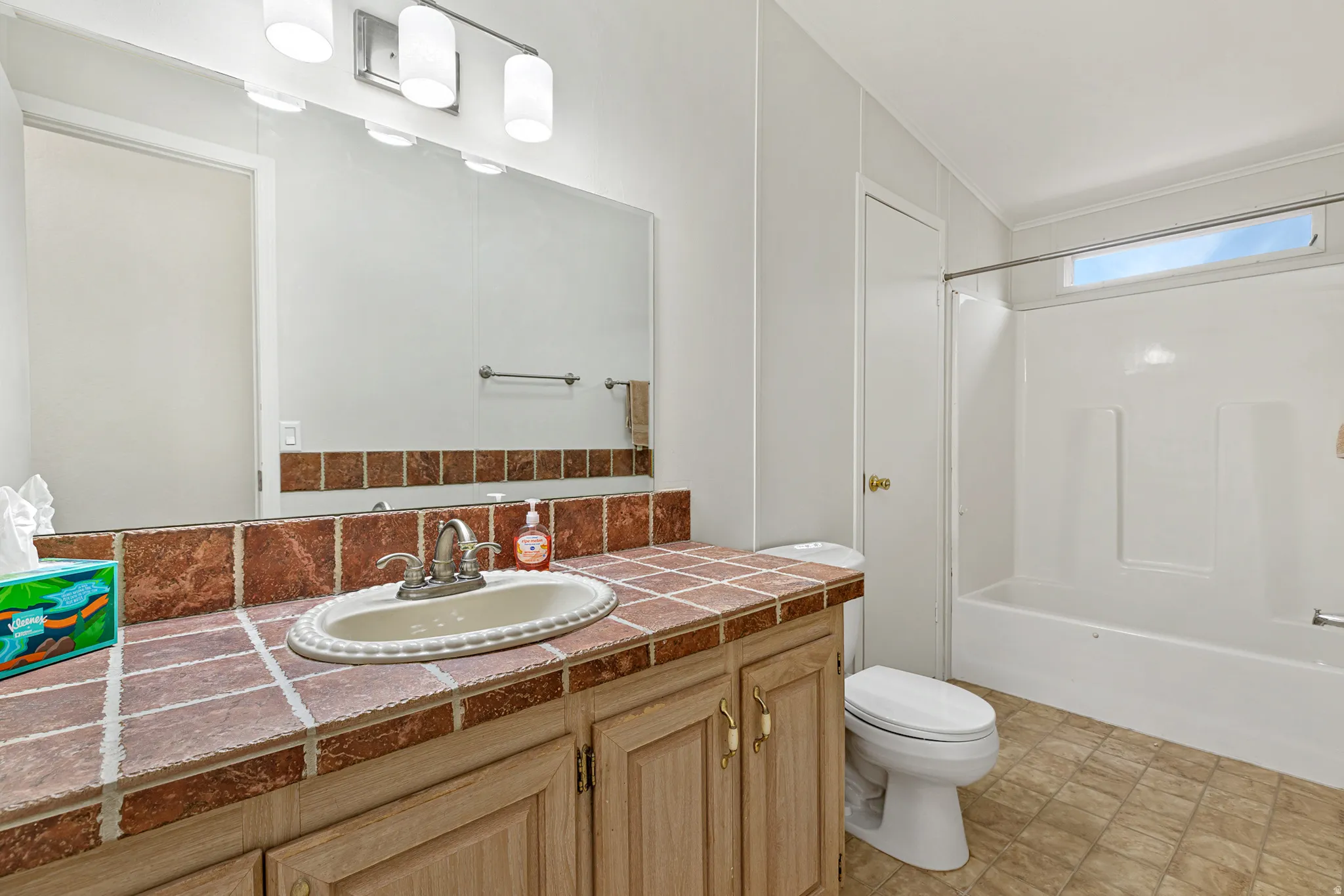 Bathroom with vanity and tub / shower combination