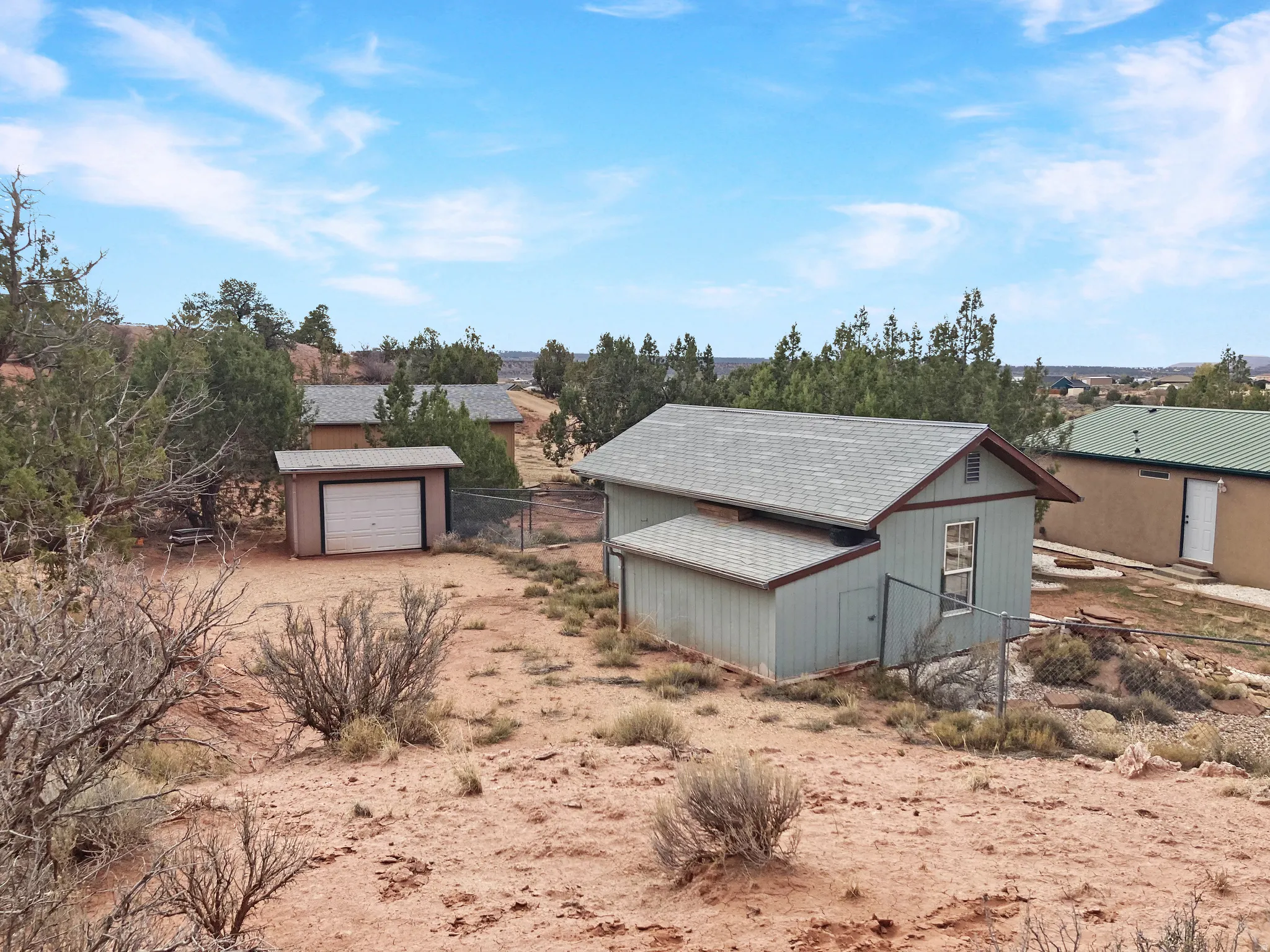 View of front of house with an outdoor structure and driveway
