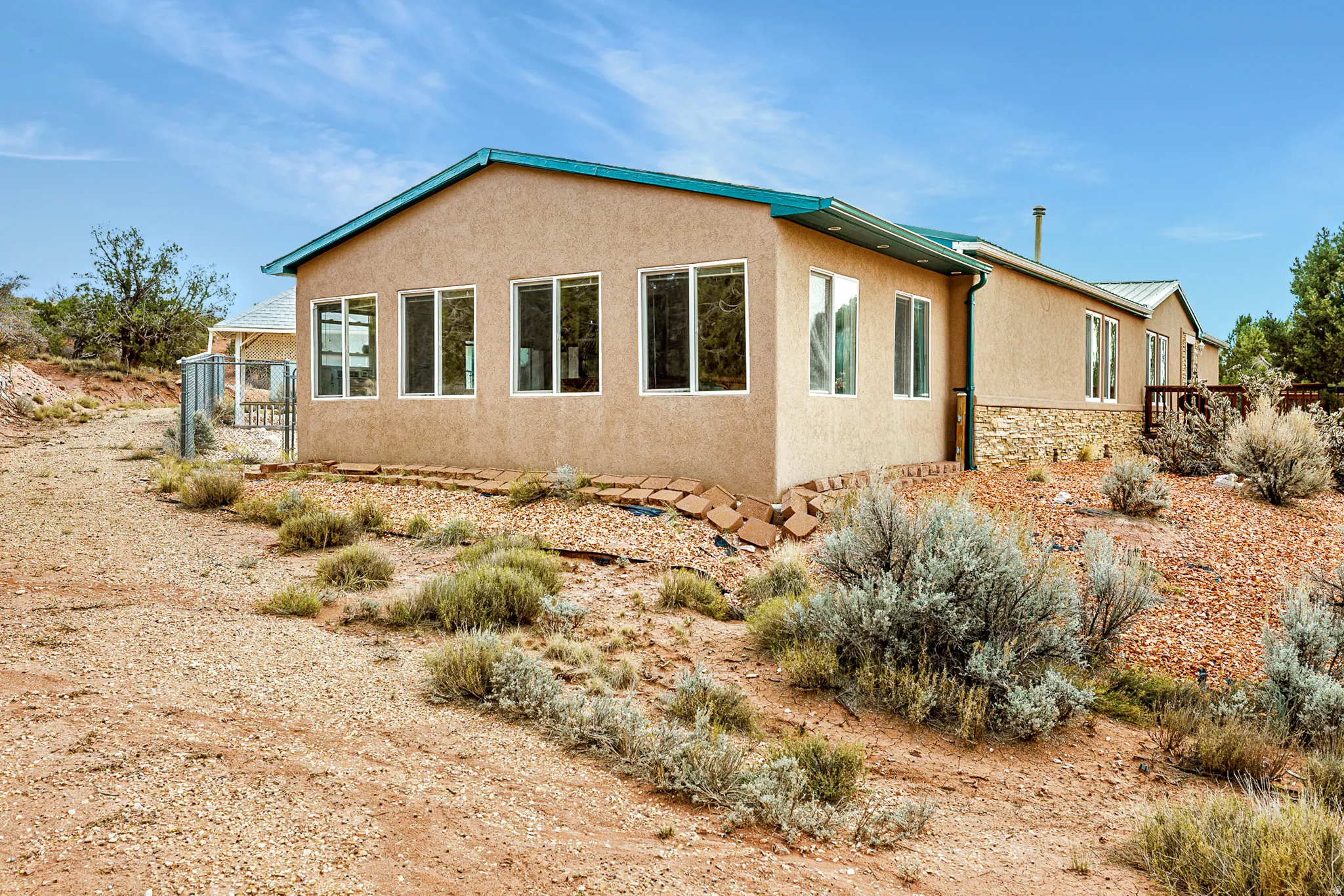 View of home's exterior with stucco siding and stone siding
