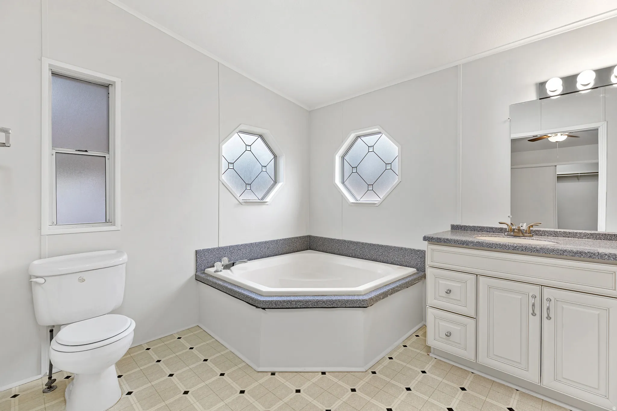 Full bathroom with a garden tub and vanity