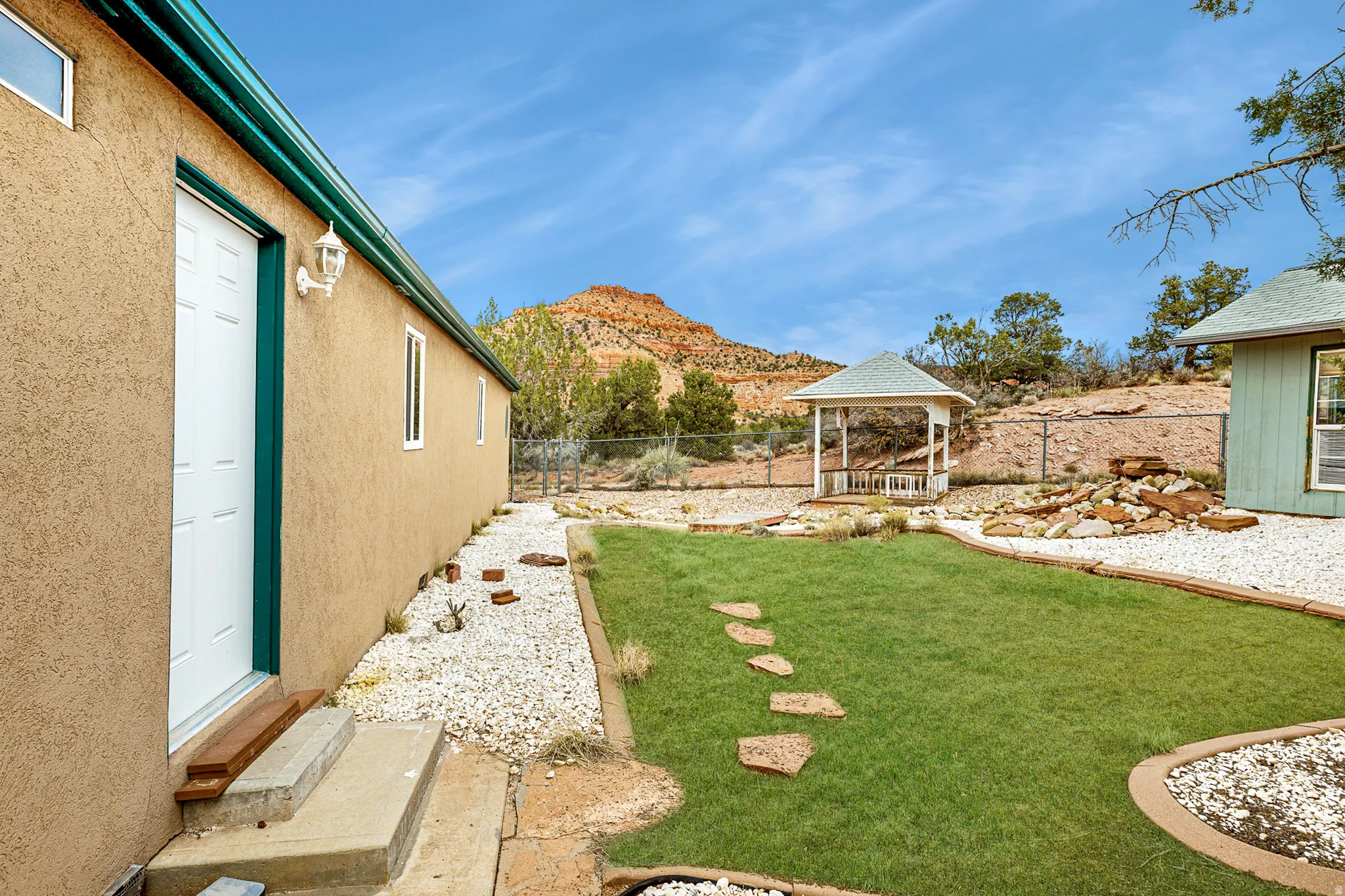 Fenced backyard featuring a gazebo and a mountain view