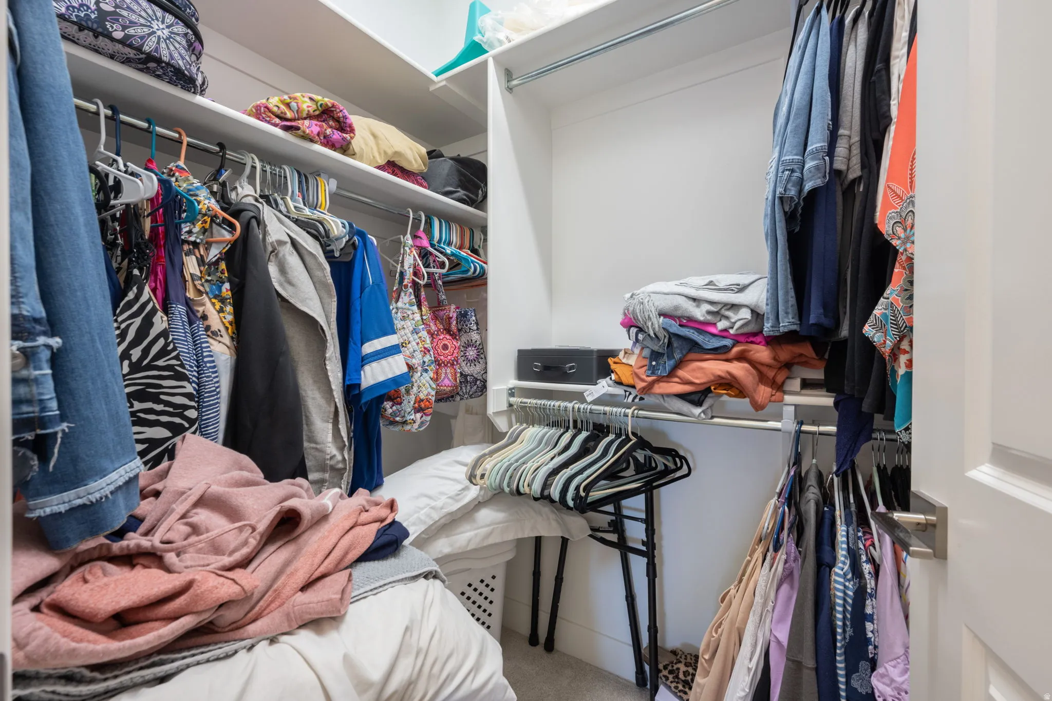 Walk in closet with light carpet