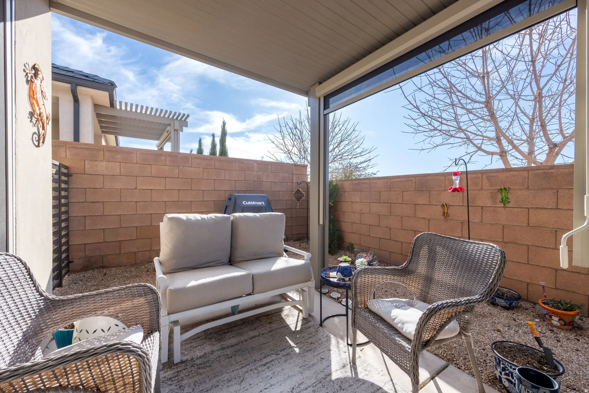 Fenced backyard with a patio and an outdoor hangout area