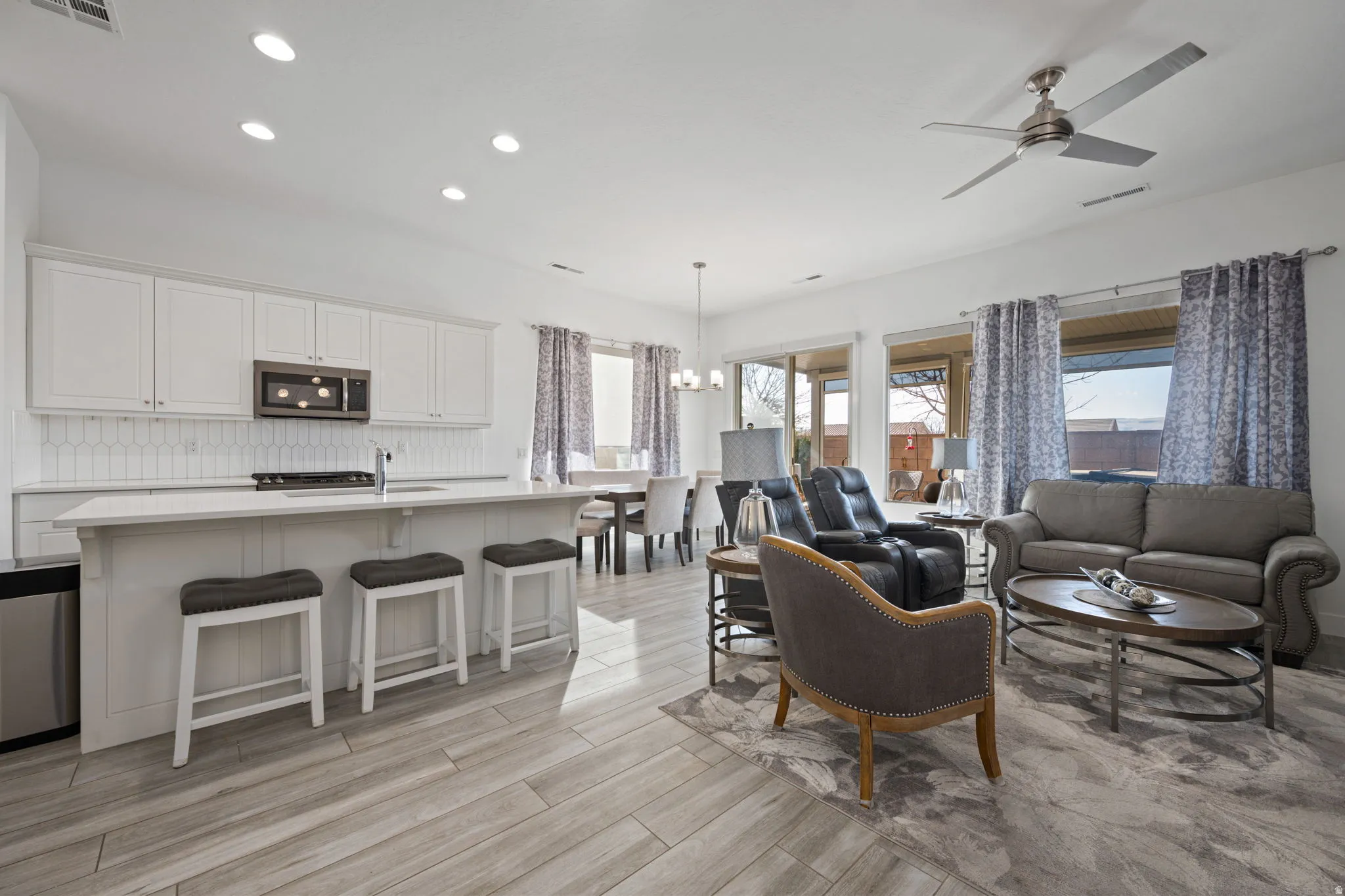Living area featuring recessed lighting, a chandelier, ceiling fan, and light wood finished floors