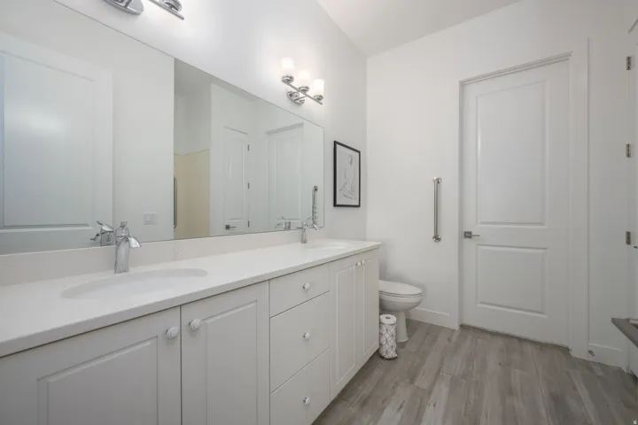 Bathroom featuring double vanity and light wood-style floors