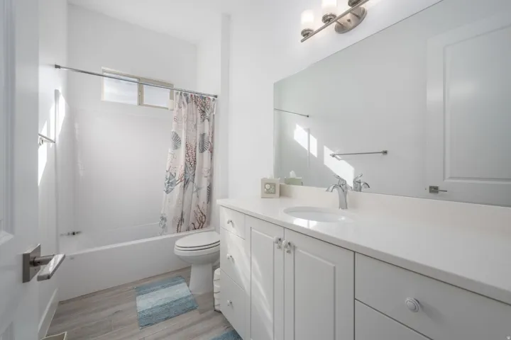 Full bathroom with shower / tub combo, vanity, and light wood-type flooring