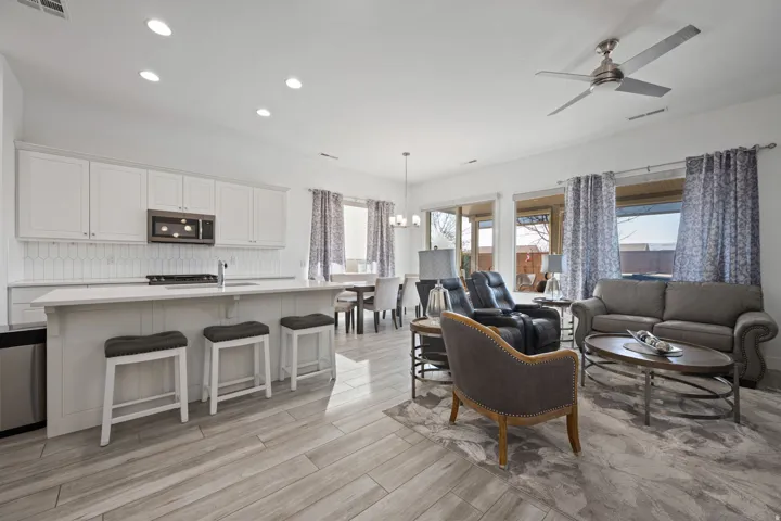 Living area featuring recessed lighting, a chandelier, ceiling fan, and light wood finished floors