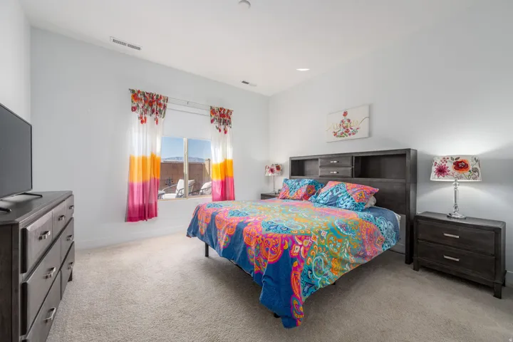 Bedroom featuring light carpet and recessed lighting