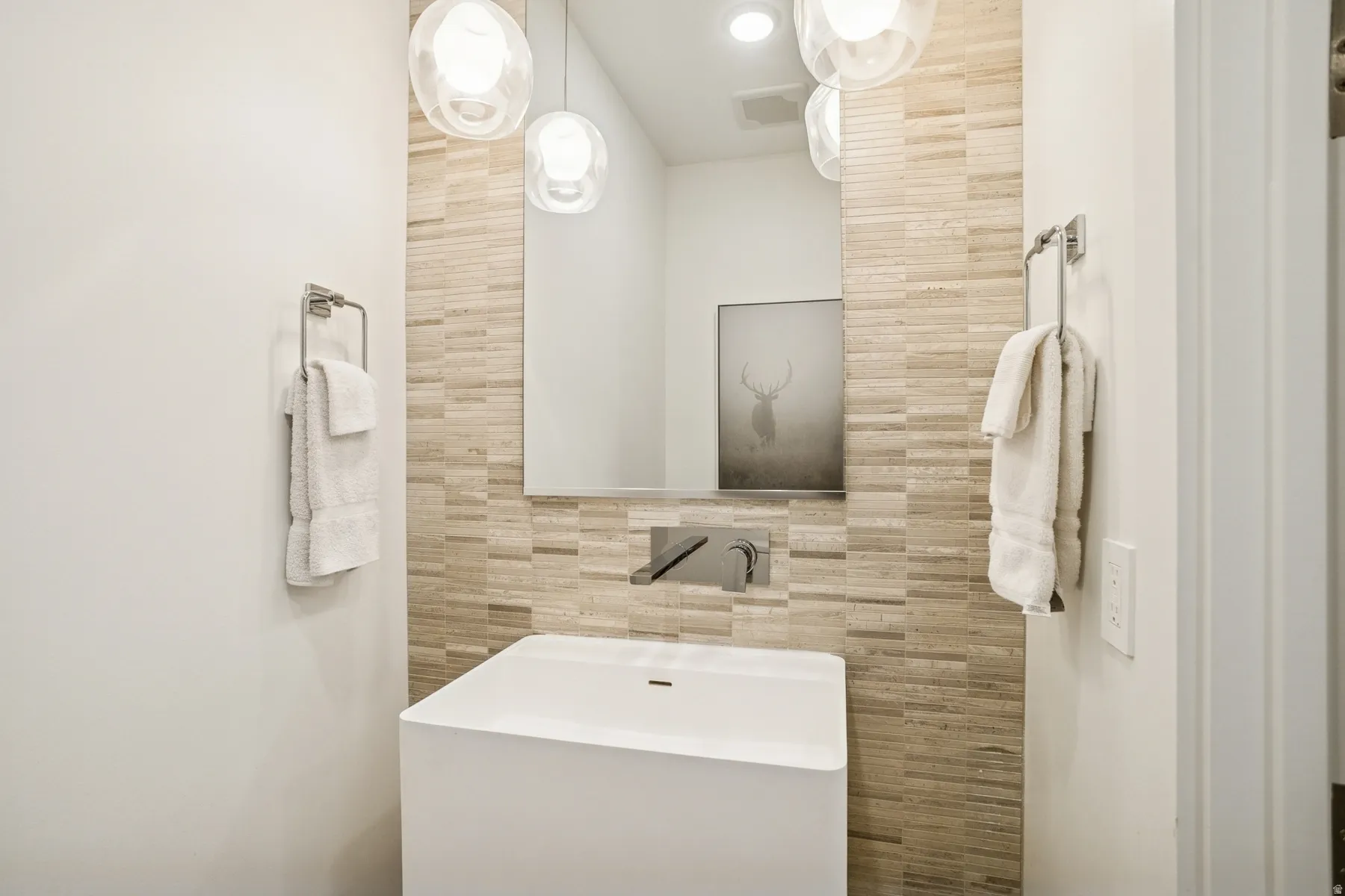 Bathroom with tile walls and vanity