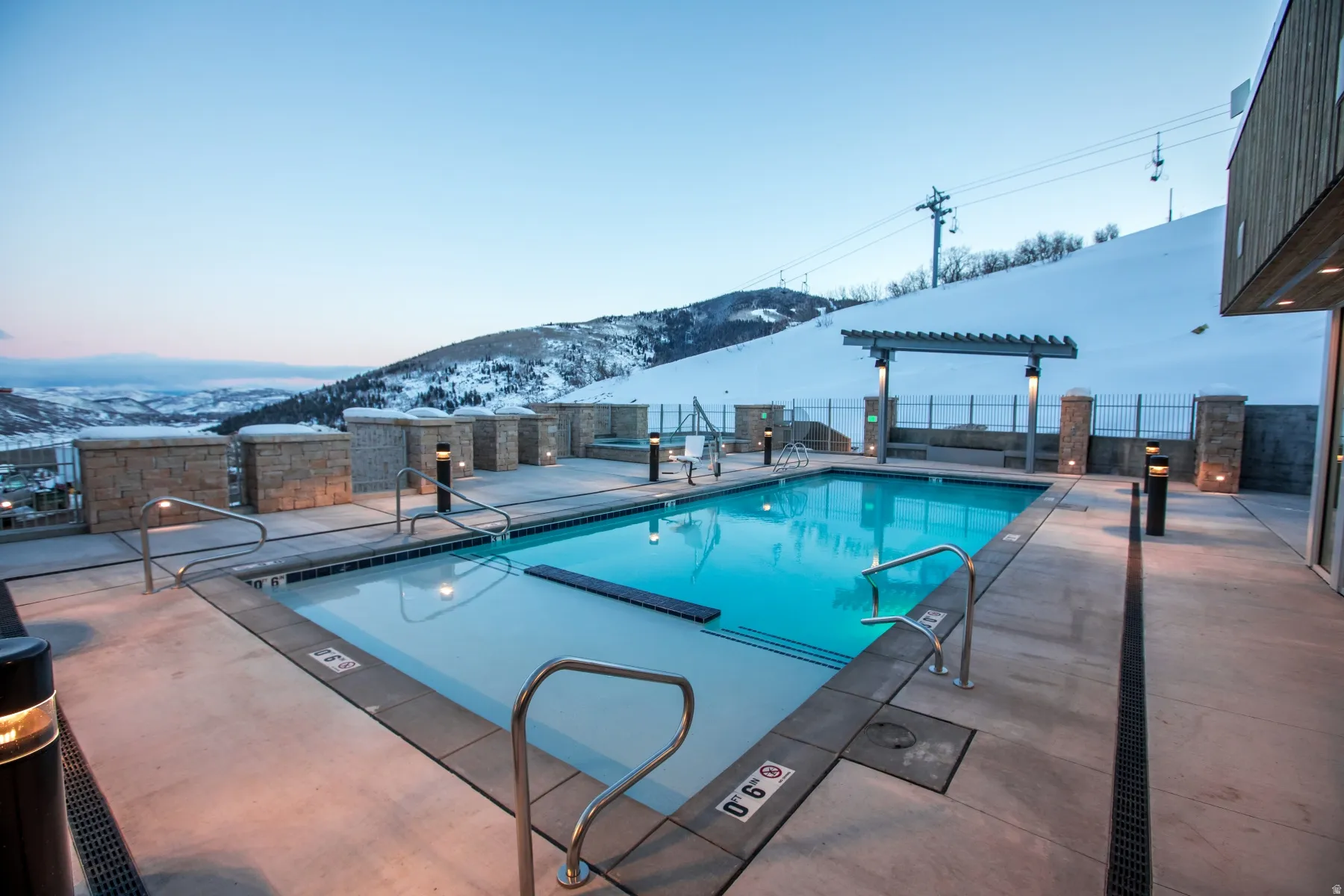 Community pool with a patio area and a mountain view