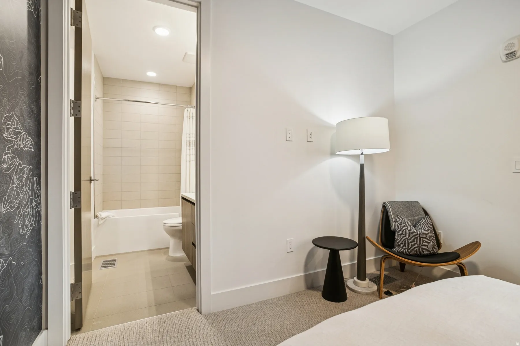 Bedroom with light tile patterned floors and recessed lighting