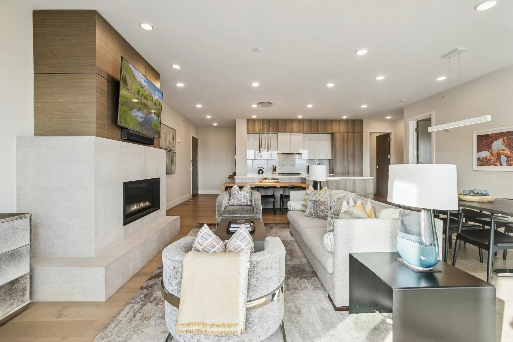 Living room with light wood-style flooring, recessed lighting, and a fireplace