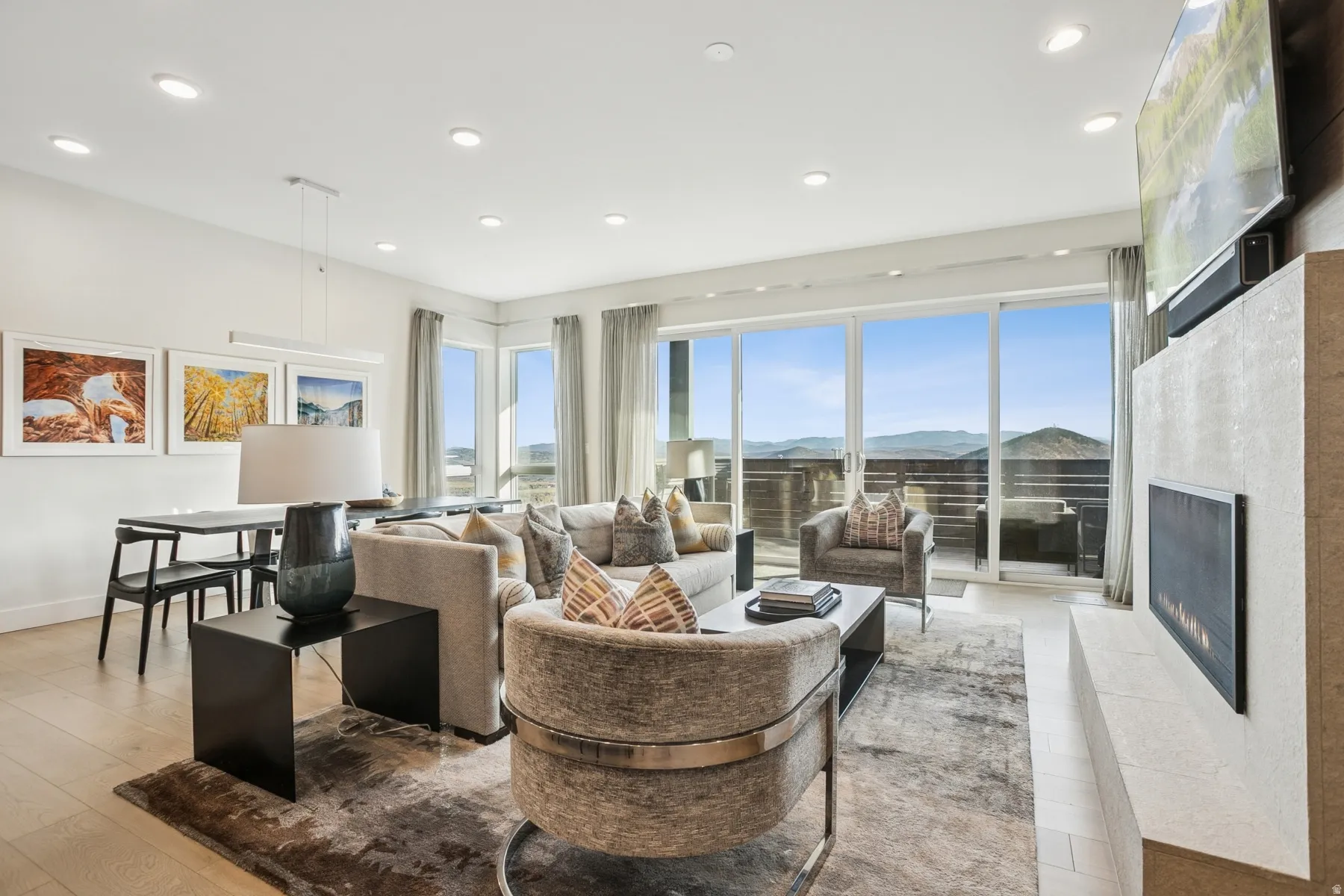 Living room with a lit fireplace, recessed lighting, and light wood-style floors