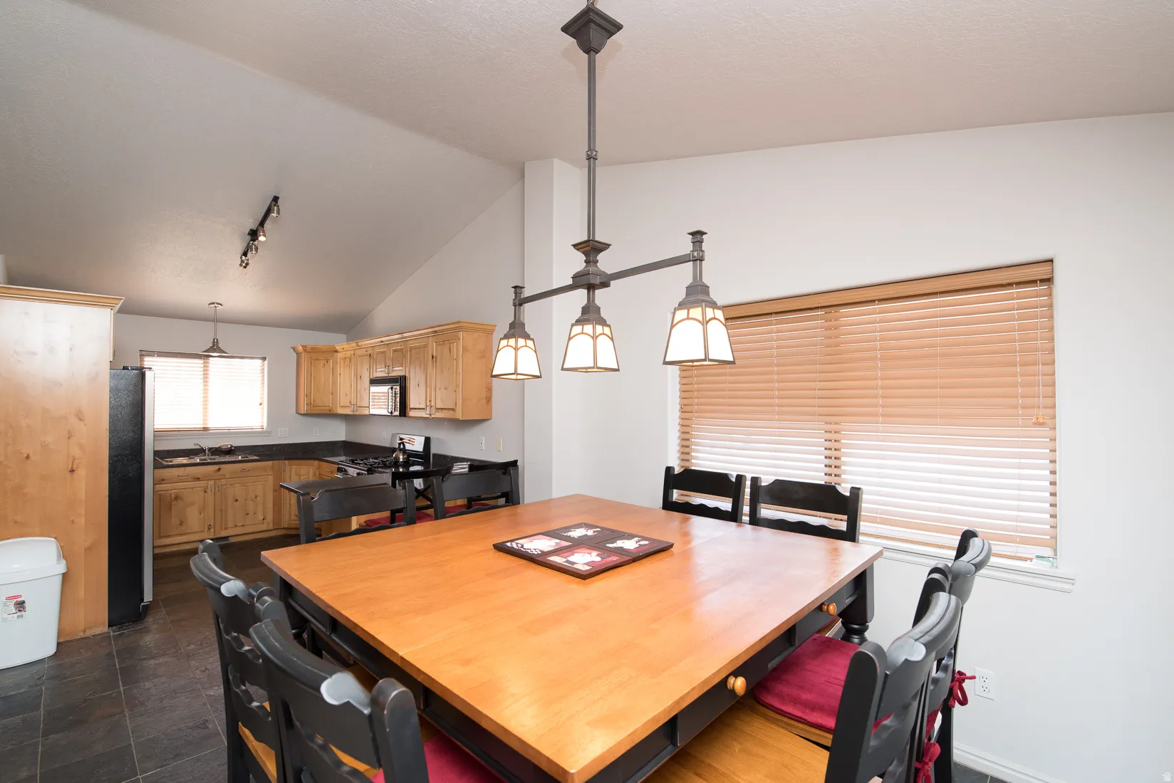 Dining area featuring high vaulted ceiling