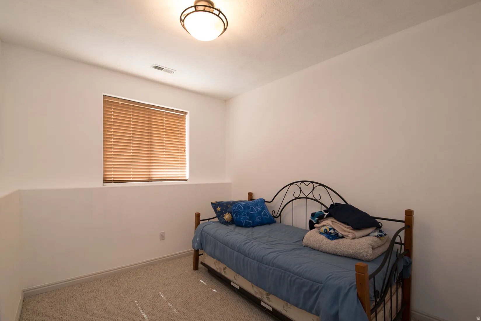 Bedroom featuring carpet floors and baseboards