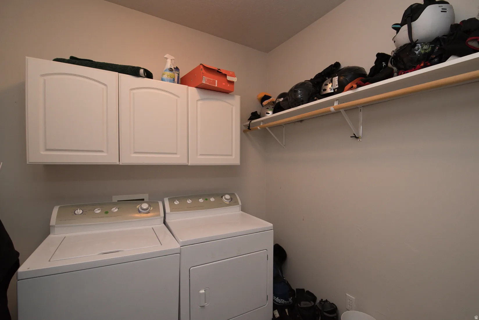 Laundry room featuring cabinet space and independent washer and dryer