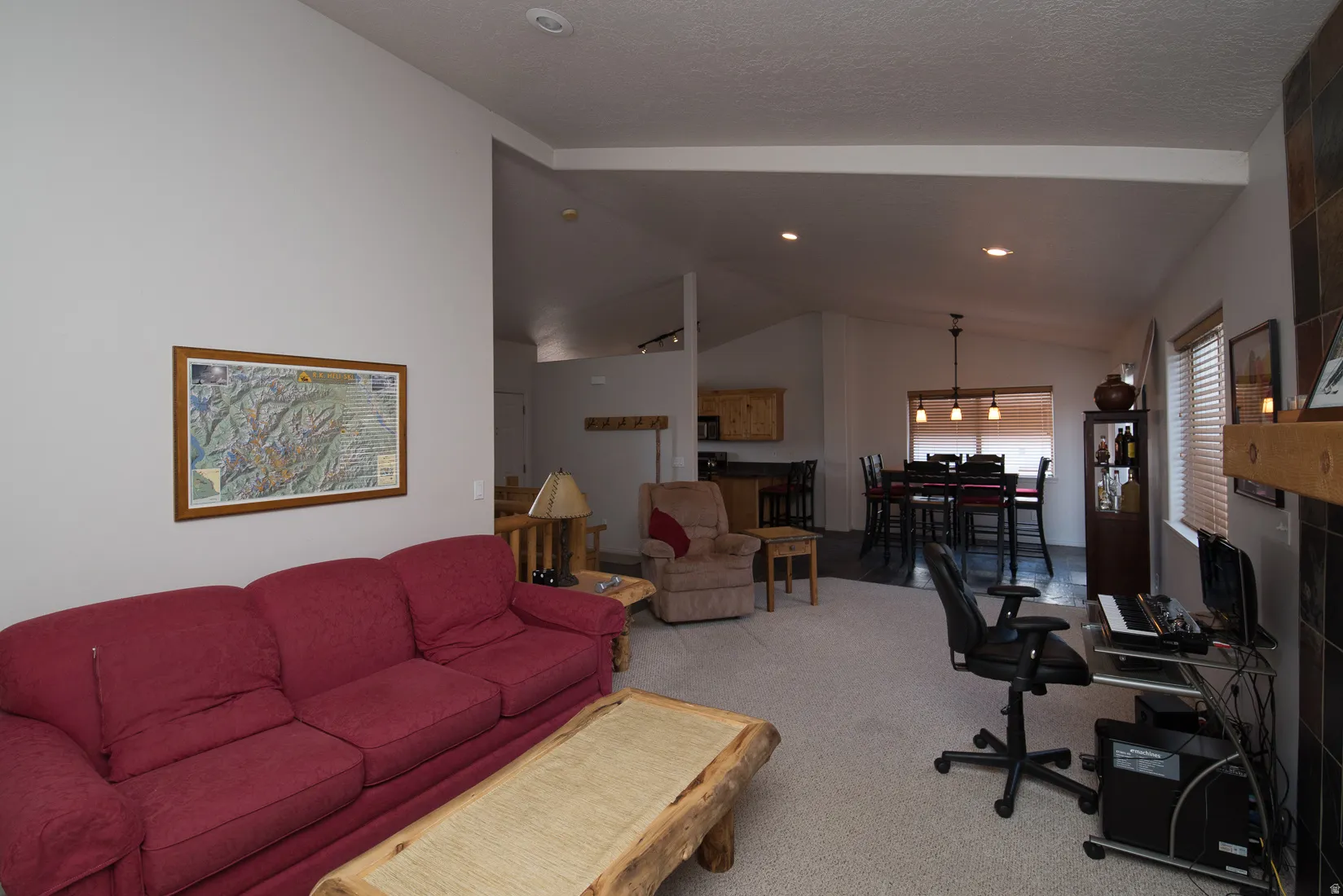 Living room with lofted ceiling and carpet