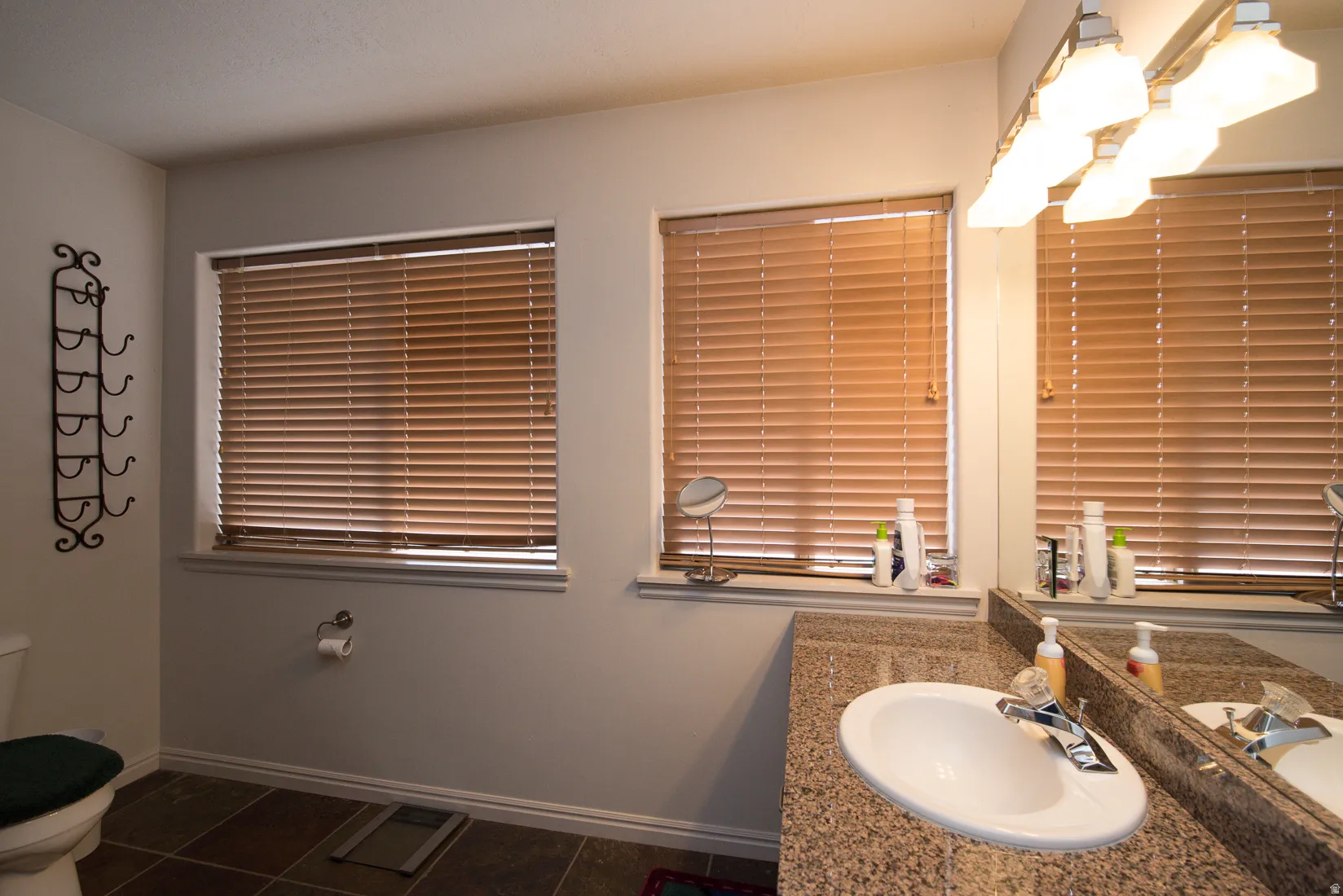 Bathroom featuring vanity and dark tile patterned flooring
