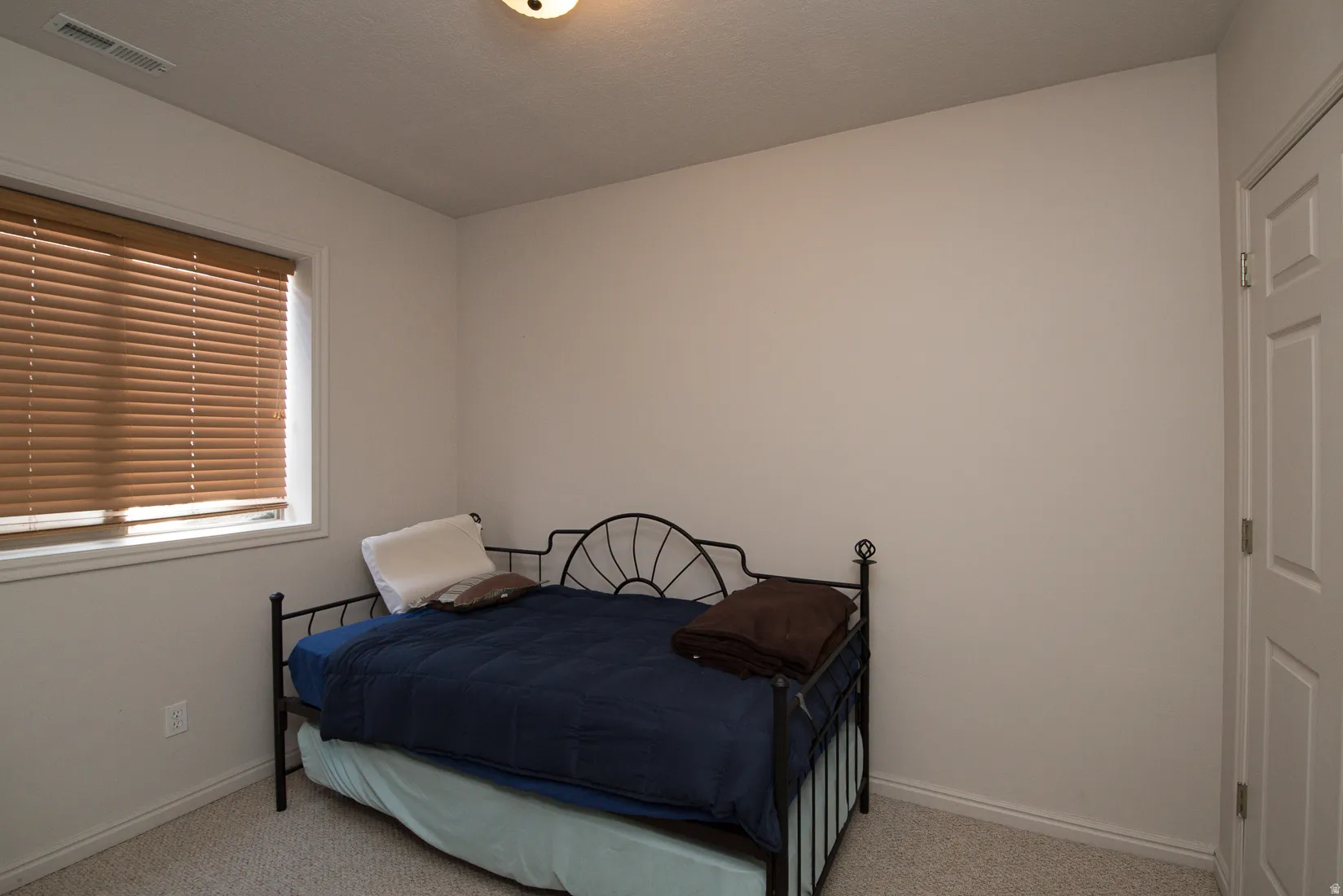 Bedroom featuring carpet flooring and baseboards