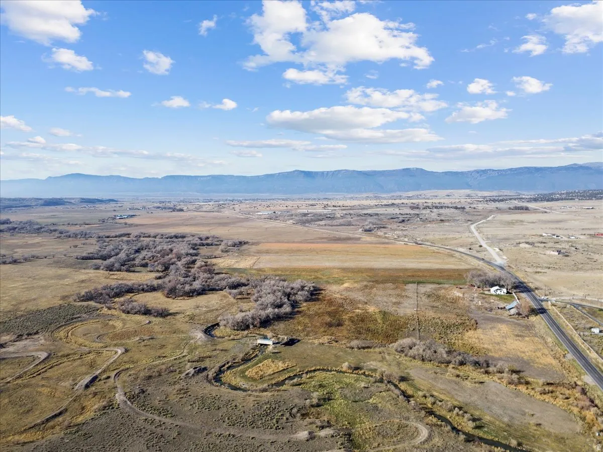 View of property location featuring a mountain backdrop and rural landscape