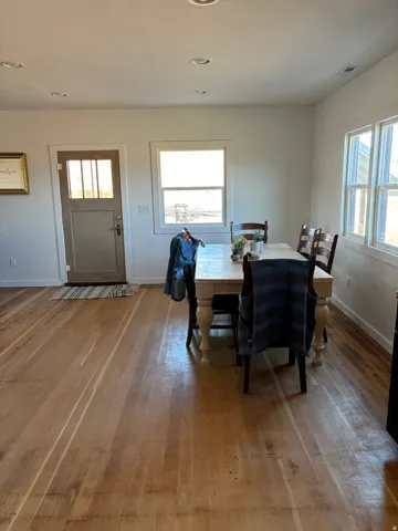 Dining space with light wood finished floors, plenty of natural light, and recessed lighting