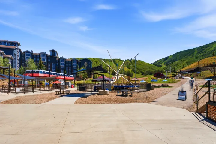 Mountain resort setting featuring multi-story buildings with dark siding and multiple windows