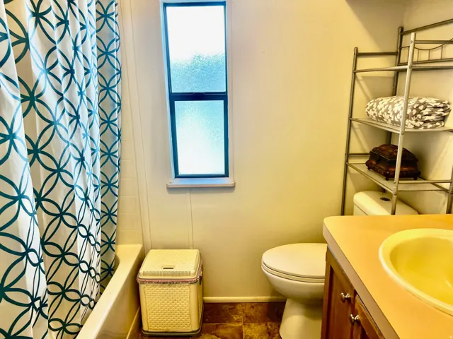 Bathroom with vanity and shower / bath combo