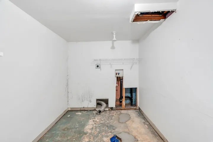 Laundry area with hookup for a washing machine, hookup for an electric dryer, and concrete flooring