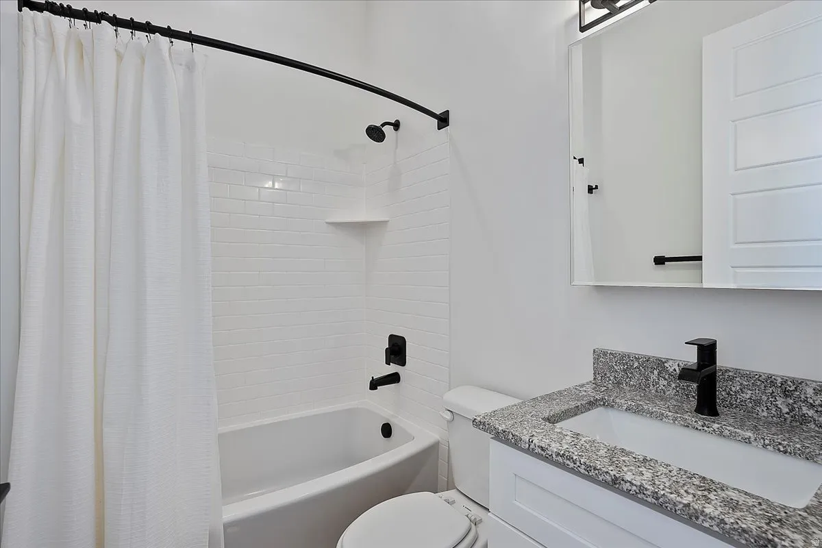 Bathroom with shower / bath combo and vanity