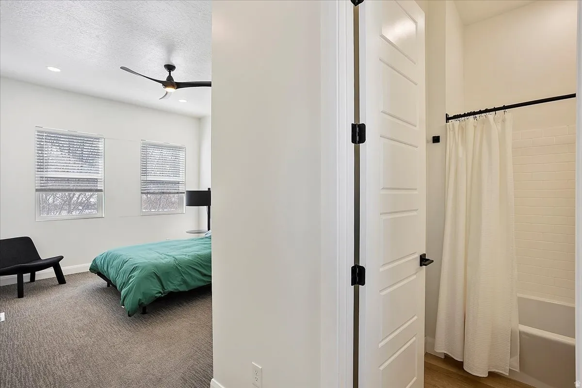 Bedroom featuring ceiling fan, a textured ceiling, recessed lighting, and dark carpet