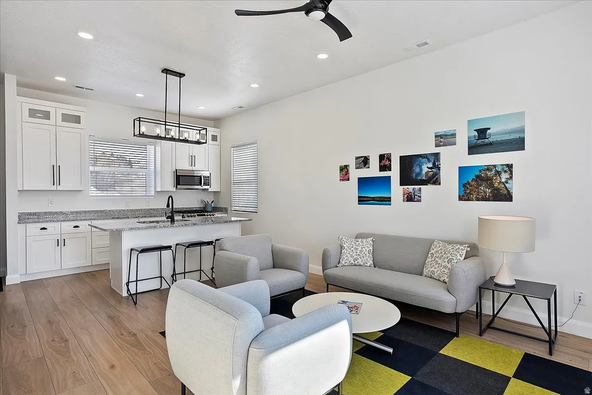 Living area featuring recessed lighting, light wood-style flooring, and ceiling fan