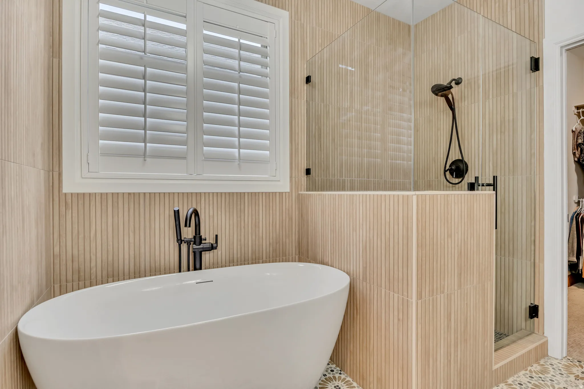 Main Level Primary Bathroom featuring a shower stall and a freestanding bath