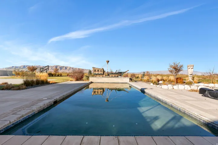 Outdoor pool with a mountain view and a patio