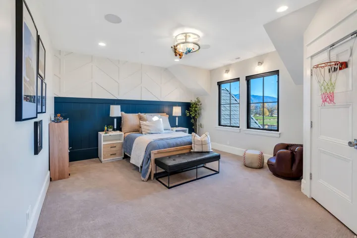 Bedroom featuring light colored carpet, an accent wall, and recessed lighting