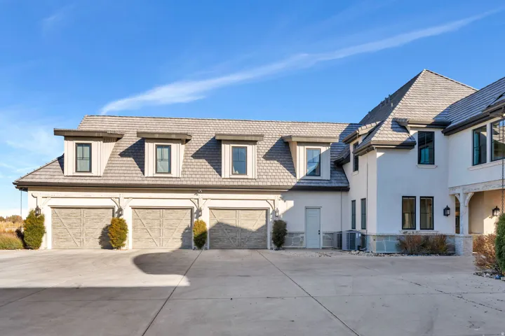 View of front of property with concrete driveway, a garage, and stucco siding