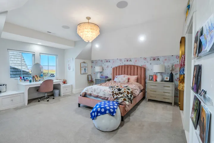 Bedroom with a desk, wallpapered walls, light colored carpet, a chandelier, and recessed lighting
