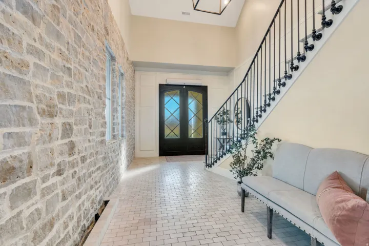 Entryway with stairway, a high ceiling, and french doors