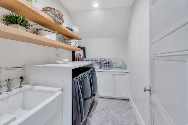 Laundry area with separate washer and dryer and cabinet space