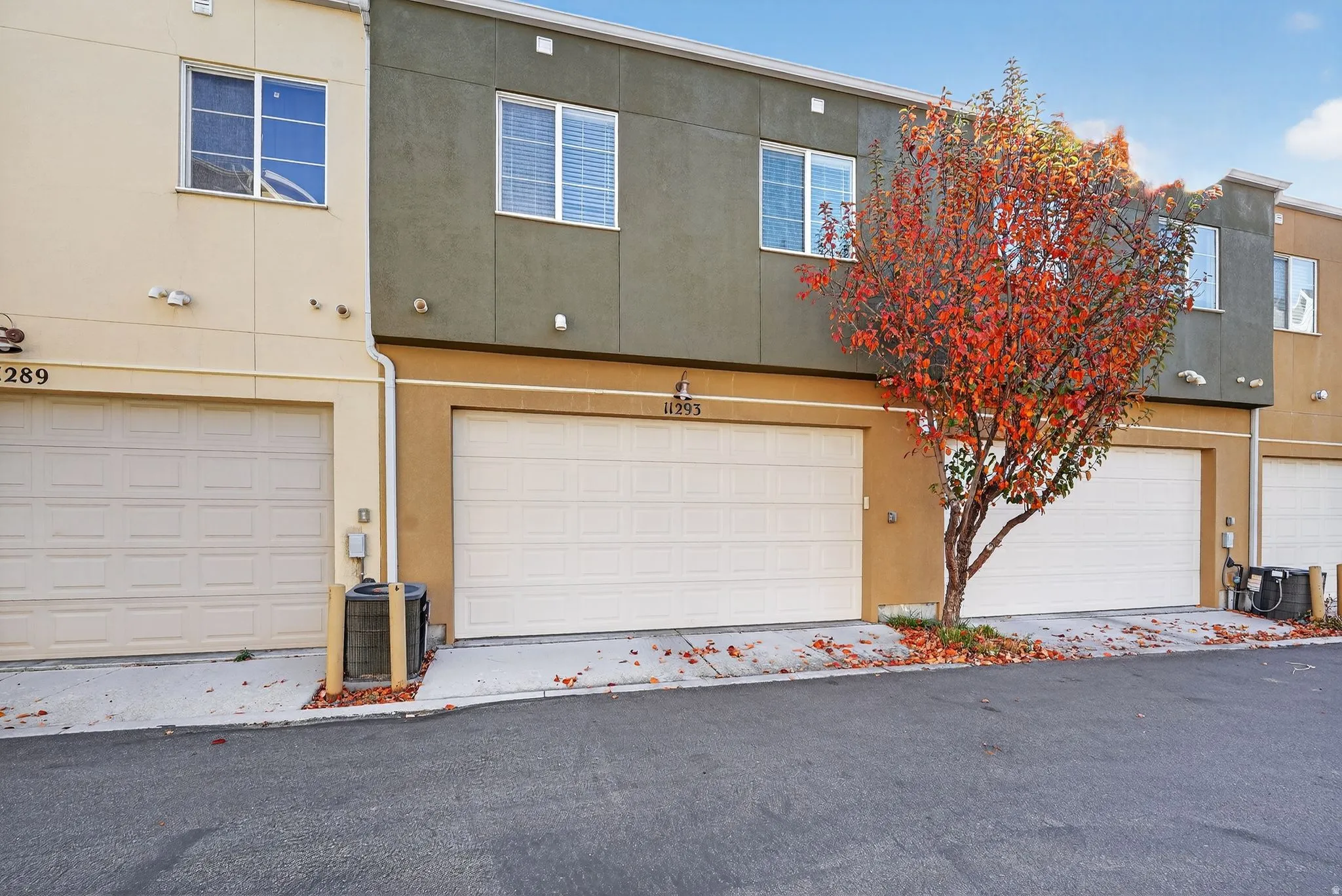 Traditional home with stucco siding and an attached garage