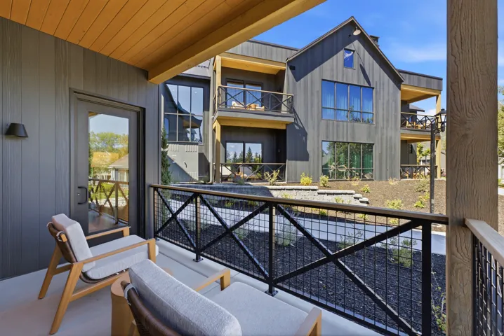 Private balcony with a concrete surface and black metal railing
