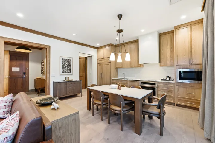 Open-concept living space with wood-finish flooring, recessed lighting, and a modern kitchen