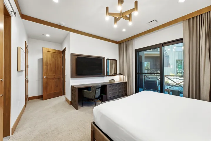 Recessed lighting, wood-finish trim, built-in desk, built-in media cabinet, and sliding glass door to exterior
