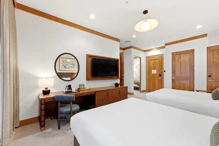 Wood-finish trim details, built-in media console, wood-finish desk, and wood-finish interior doors