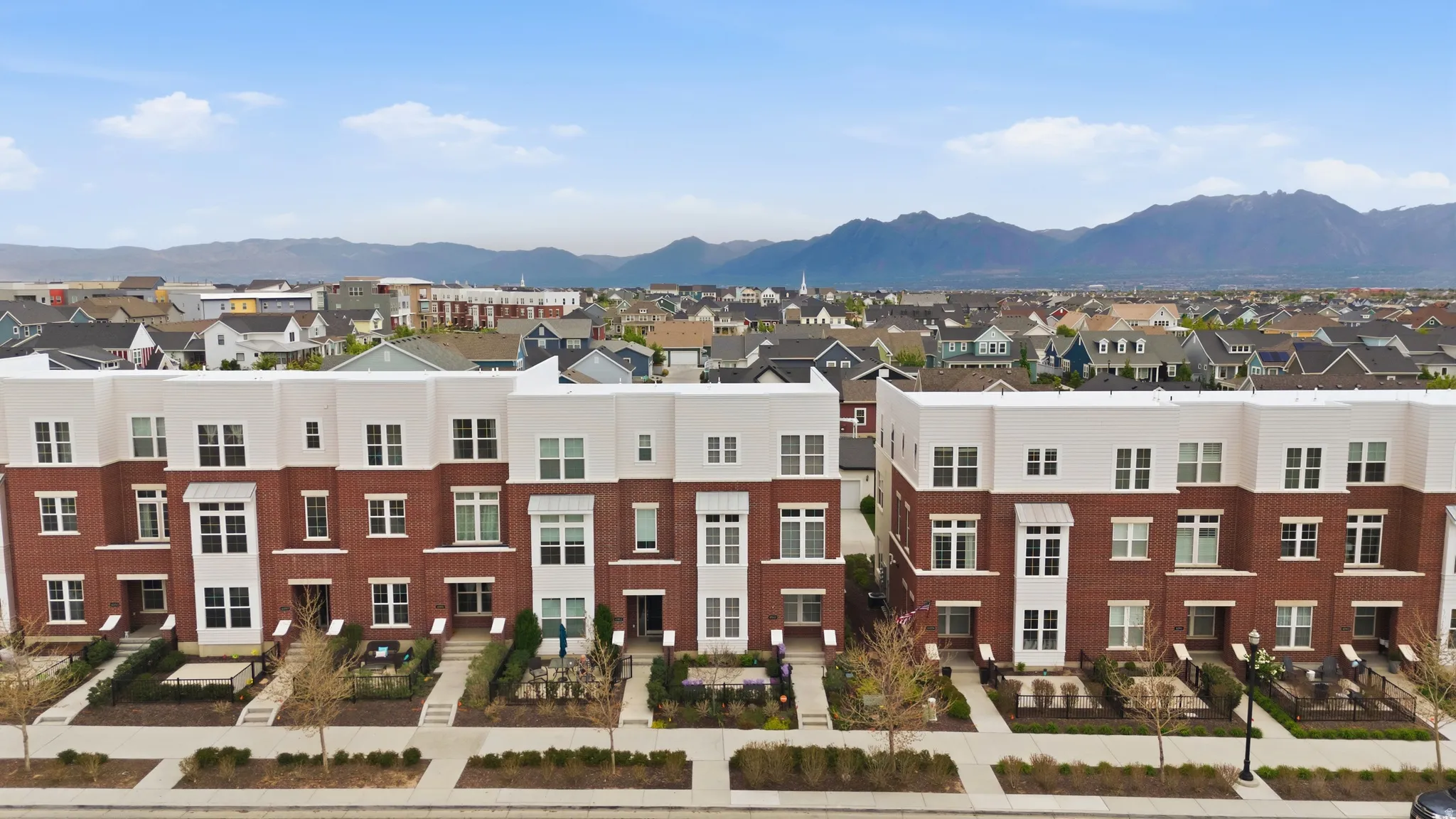 Townhome community featuring brick and light-toned siding exteriors